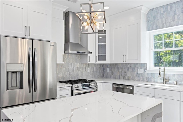 kitchen featuring a sink, wall chimney exhaust hood, white cabinetry, and stainless steel appliances