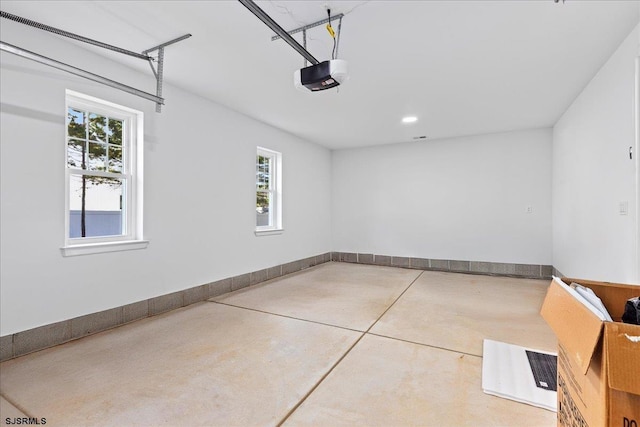 garage with a garage door opener and baseboards