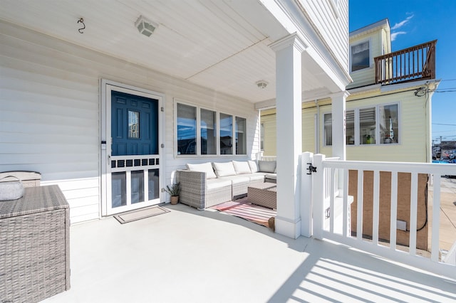 view of patio with an outdoor living space and a porch