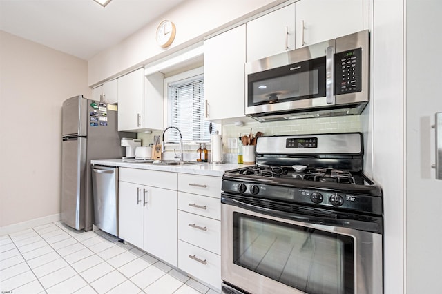 kitchen featuring light countertops, white cabinets, tasteful backsplash, and appliances with stainless steel finishes