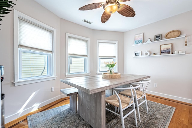 dining area featuring a wealth of natural light, visible vents, and baseboards