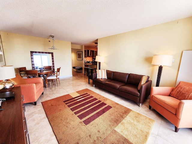 living room featuring light tile patterned floors and a textured ceiling