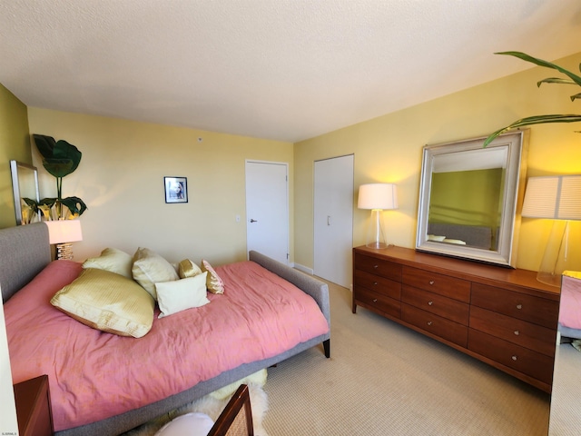 bedroom featuring light carpet