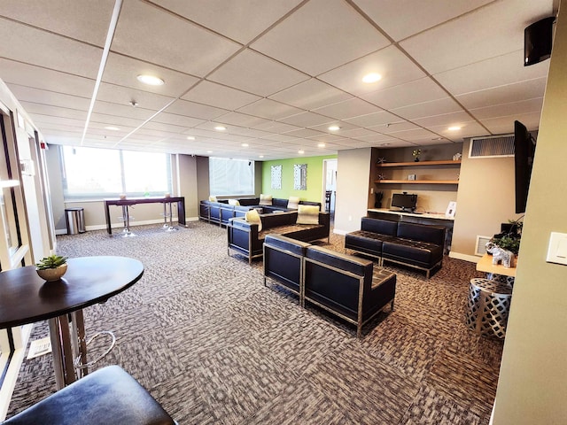 carpeted living area featuring a drop ceiling, recessed lighting, visible vents, and baseboards