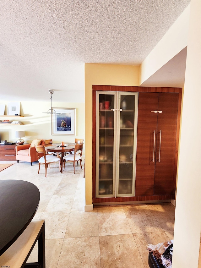 hallway with a textured ceiling