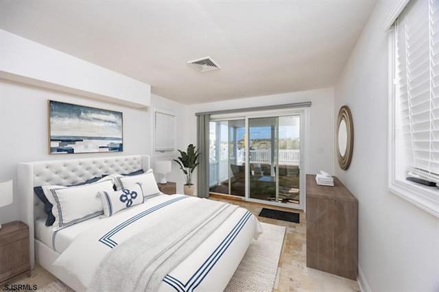 bedroom featuring visible vents, baseboards, and access to outside