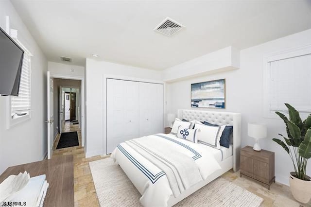 bedroom with visible vents and a closet