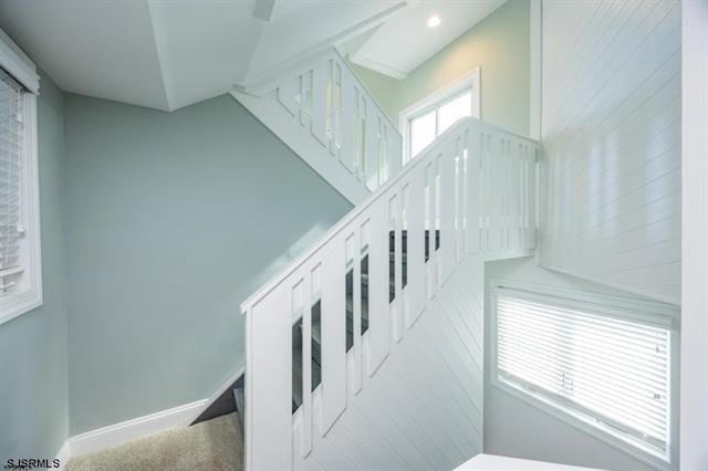 stairway with recessed lighting, baseboards, and carpet