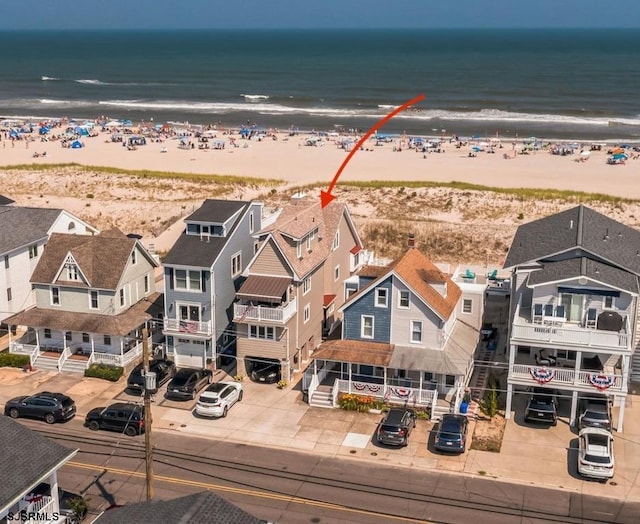 aerial view with a water view and a view of the beach