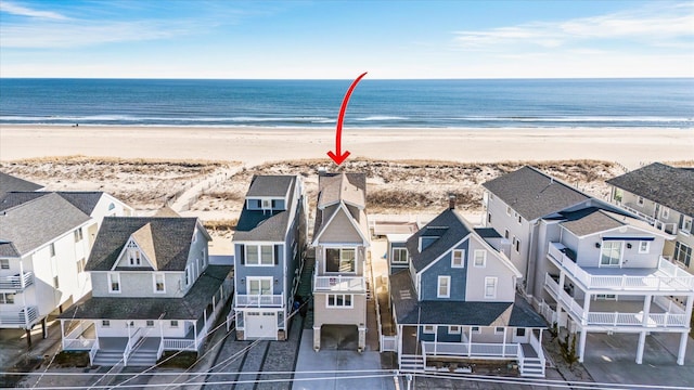 aerial view featuring a residential view, a water view, and a view of the beach