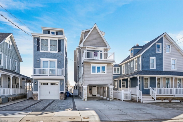 view of front of home featuring an attached garage, a porch, and driveway