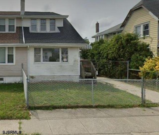 exterior space with a front lawn, a fenced front yard, and crawl space