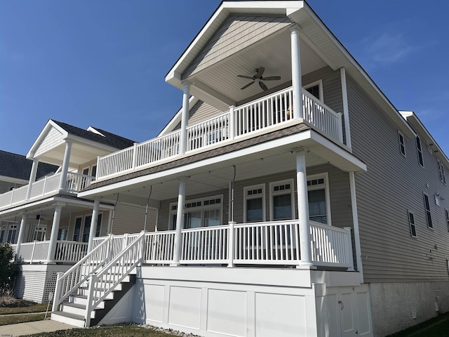 view of front of home with a porch, a balcony, and a ceiling fan