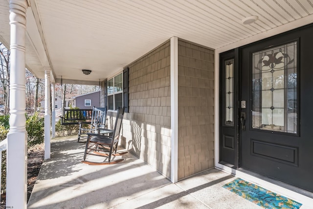 view of exterior entry with a porch