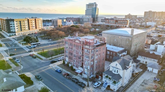 drone / aerial view featuring a city view and a water view