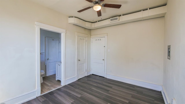 unfurnished bedroom featuring visible vents, dark wood-type flooring, ceiling fan, baseboards, and ensuite bathroom