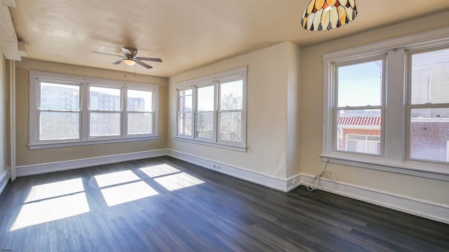 unfurnished sunroom with ceiling fan