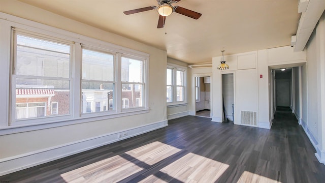 interior space featuring dark wood finished floors, baseboards, visible vents, and a ceiling fan