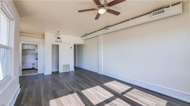 unfurnished bedroom featuring visible vents, baseboards, and dark wood finished floors