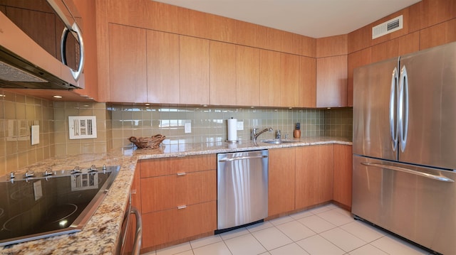 kitchen featuring visible vents, light stone counters, tasteful backsplash, appliances with stainless steel finishes, and light tile patterned flooring