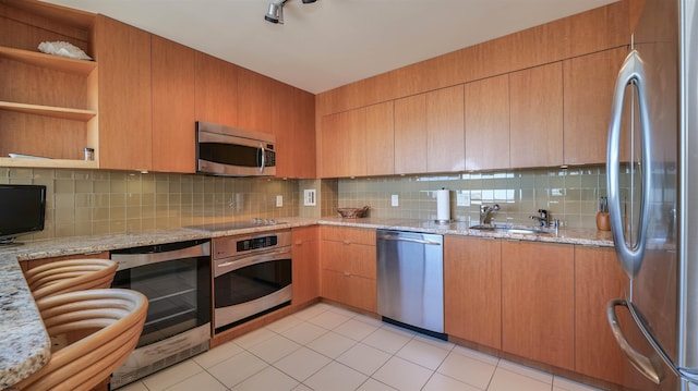 kitchen with a sink, beverage cooler, tasteful backsplash, and stainless steel appliances