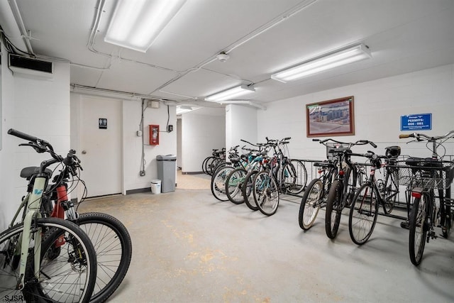 garage with bike storage and concrete block wall