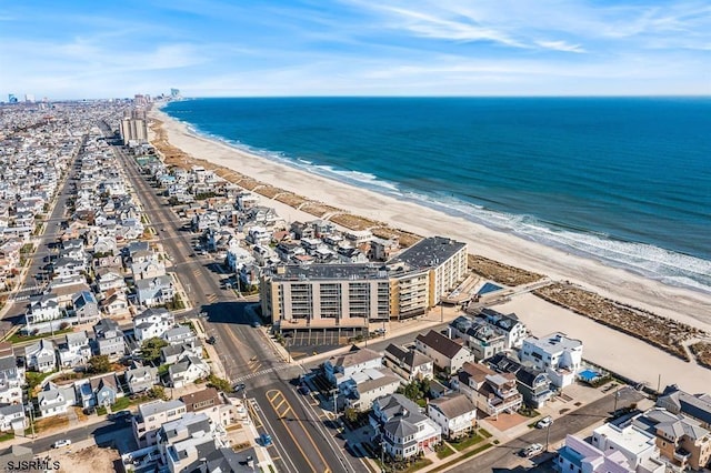 drone / aerial view featuring a water view and a view of the beach