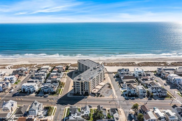 drone / aerial view featuring a view of the beach and a water view