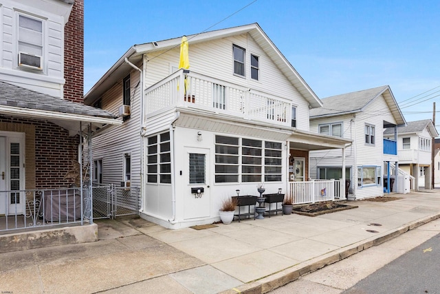 exterior space with a balcony and a gate