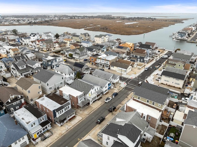 drone / aerial view with a water view and a residential view