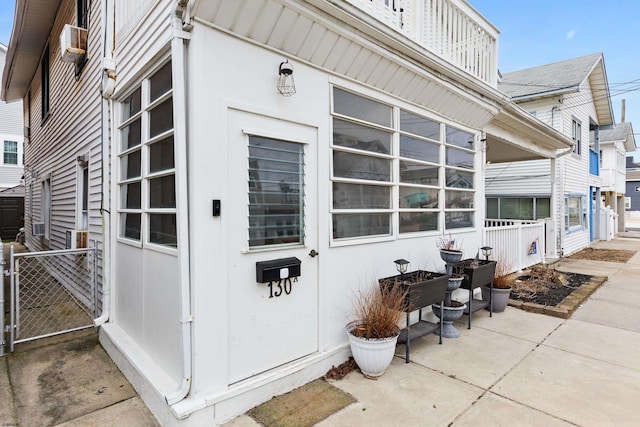 view of property exterior with cooling unit and fence