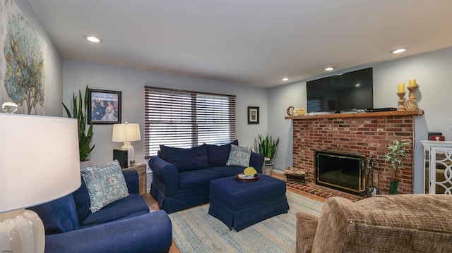 living area featuring recessed lighting and a fireplace