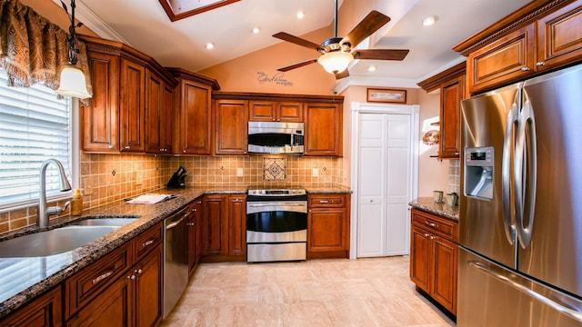 kitchen featuring a sink, vaulted ceiling, crown molding, and stainless steel appliances