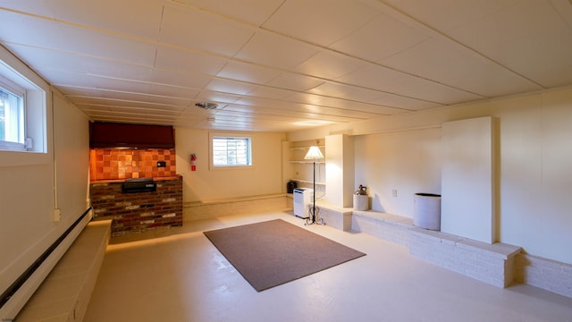 workout area featuring a baseboard heating unit