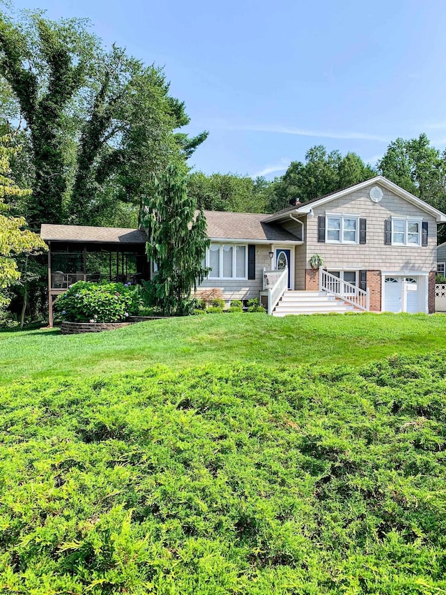 tri-level home with a front yard and an attached garage