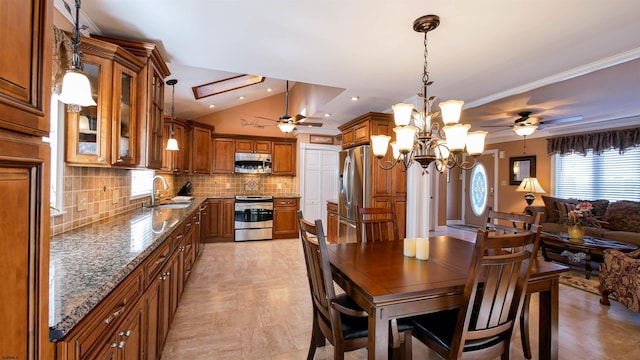 dining room with ceiling fan with notable chandelier, vaulted ceiling, recessed lighting, and ornamental molding