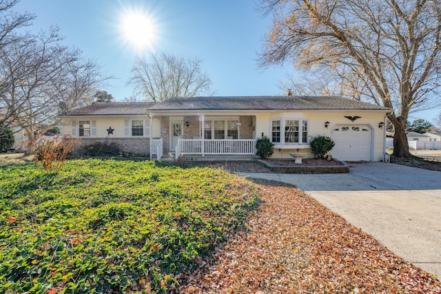 ranch-style house featuring brick siding, an attached garage, a porch, and driveway