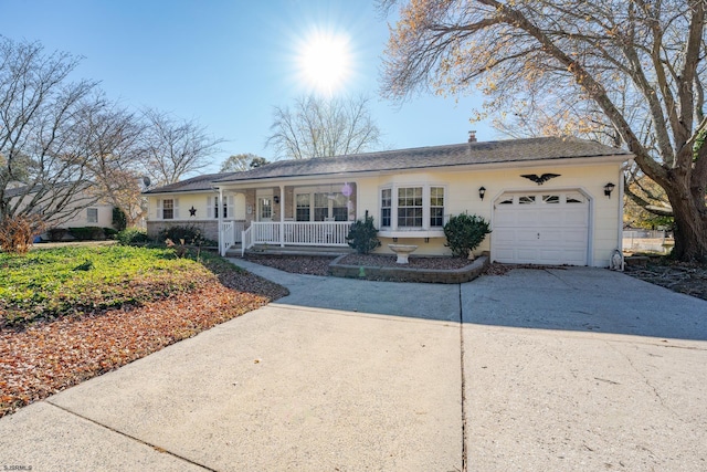 ranch-style house featuring a porch, concrete driveway, and an attached garage