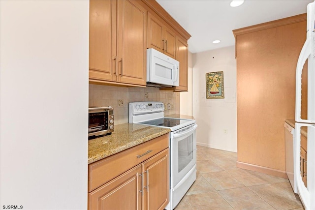 kitchen with baseboards, light stone counters, decorative backsplash, light tile patterned flooring, and white appliances