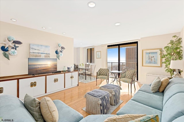 living room with recessed lighting and light wood-style floors