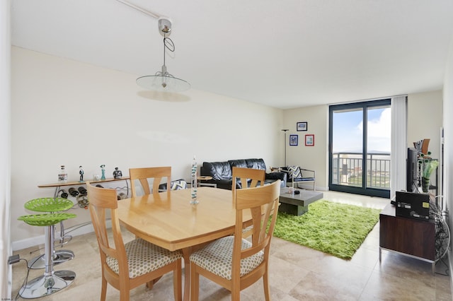 dining space with light tile patterned floors and baseboards