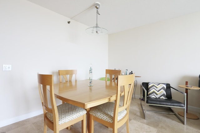 dining room with baseboards and an inviting chandelier