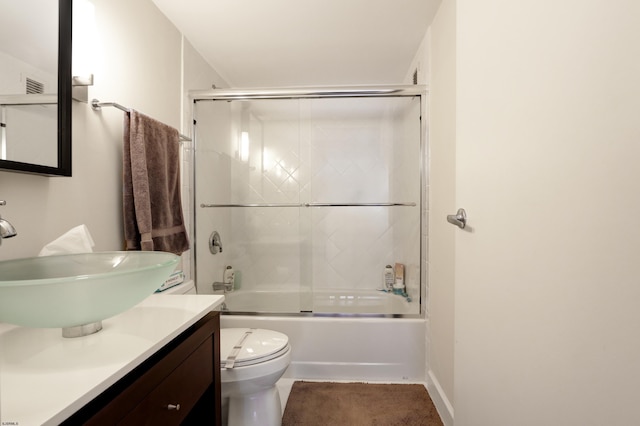 full bathroom with shower / bath combination with glass door, vanity, and toilet