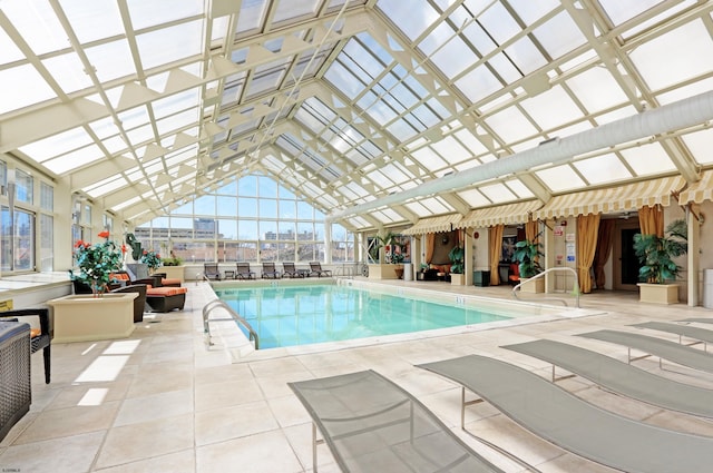 pool featuring a patio area and glass enclosure