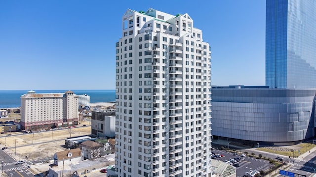 view of building exterior featuring a city view and a water view