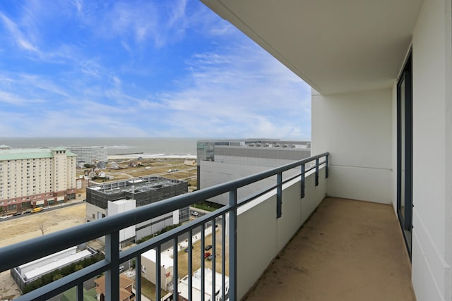 balcony featuring a city view and a water view