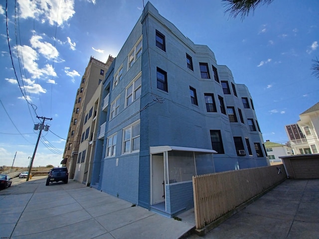 view of building exterior with fence