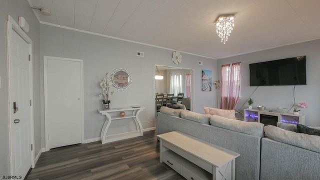 living area featuring visible vents, baseboards, dark wood-style floors, and crown molding