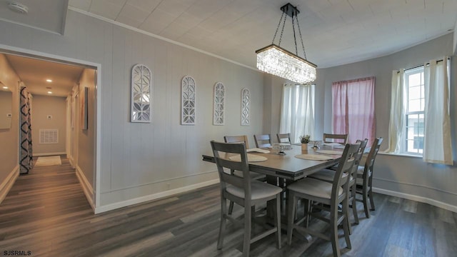 dining area featuring visible vents, dark wood-style floors, baseboards, and ornamental molding