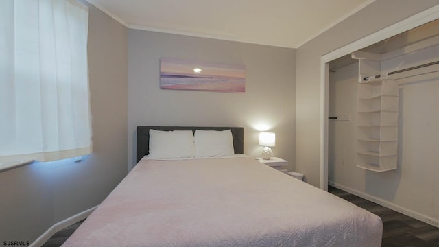 bedroom featuring dark wood-type flooring, baseboards, and ornamental molding